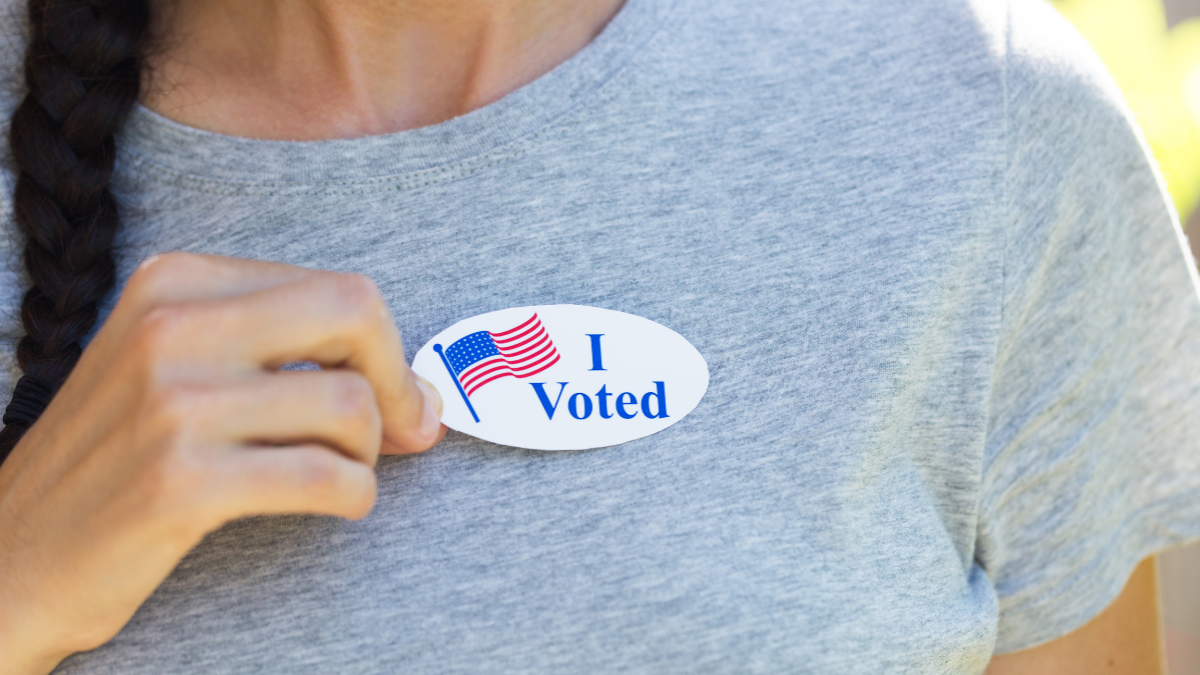 woman wearing 'i voted' sticker